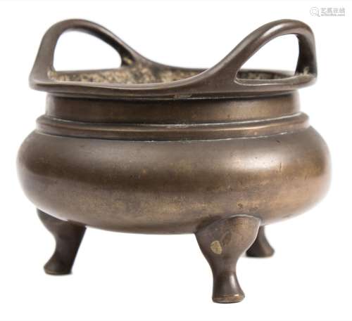 A Chinese bronze tripod censer: the compressed globular body with waisted neck and loop handles,