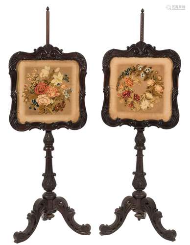 A pair of Victorian carved simulated rosewood polescreens:,