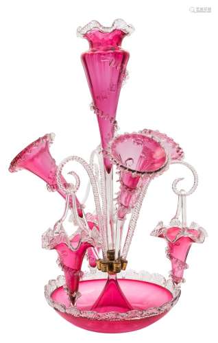 A cranberry glass table epergne: with central vase set in a circular bowl and flanked by three