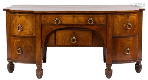 A Regency mahogany and ebony strung sideboard:, of bowed breakfront outline,