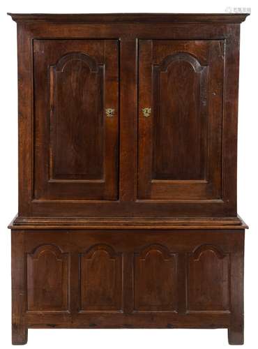 An 18th Century oak side cupboard:, in two parts, with a moulded cornice,