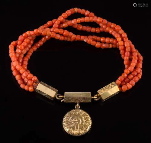 A 19th century coral mounted five-strand bracelet: suspending circular locket with glazed