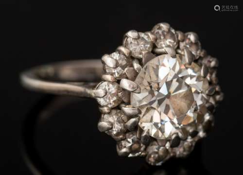 A diamond cluster ring: the round old, brilliant-cut diamond approximately 8.9mm diameter x 5.