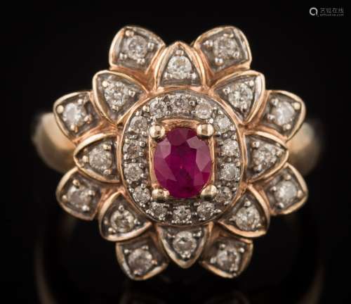 An 9ct gold, ruby and diamond oval cluster ring: with central oval ruby approximately 5mm x 4mm,