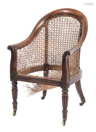 A Regency carved rosewood bergere armchair: with reeded and anthemion decoration,