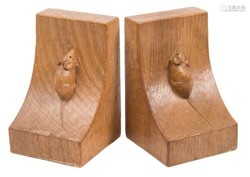 A pair of Robert Thompson (Mouseman) carved oak bookends: of swept square form,