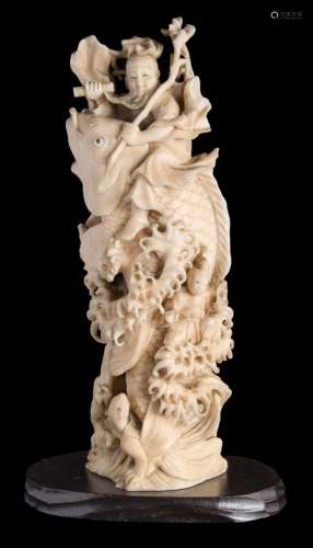 A Japanese carved ivory okimono, of Kinko Sennin, riding on the back of a carp: unsigned,