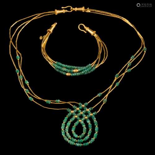 A Middle Eastern gold coloured bead and emerald bead necklace: with 'shepherd's crook' clasp and