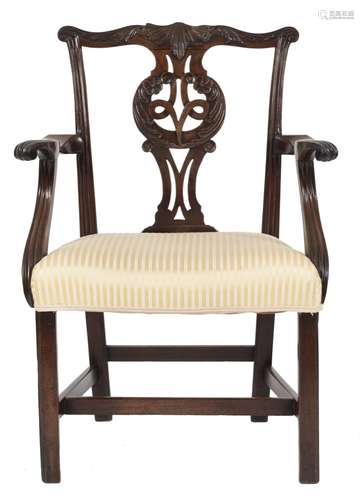 A George III carved mahogany elbow chair in the Chippendale taste:,