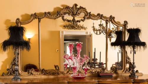 A cream and gilt heightened landscape overmantel mirror:, of cartouche shaped outline,