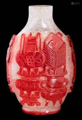 A Chinese Peking overlay glass snuff bottle: of oval form carved with auspicious objects,