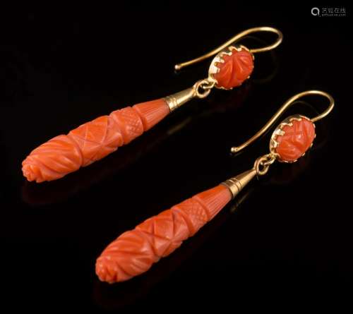 A pair of carved coral drop earrings: each with a single oval coral panel suspending a single coral