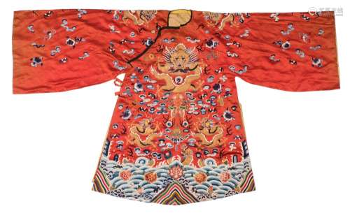 A Chinese embroidered silk court robe: decorated with dragons and bats amongst clouds,