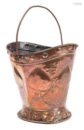 An Art Nouveau period copper coal scuttle by Benham and Froud: of oval tapering form with embossed