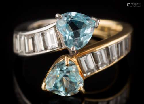 A heart-shaped aquamarine two-stone crossover ring: with heart-shaped aquamarines between shoulders