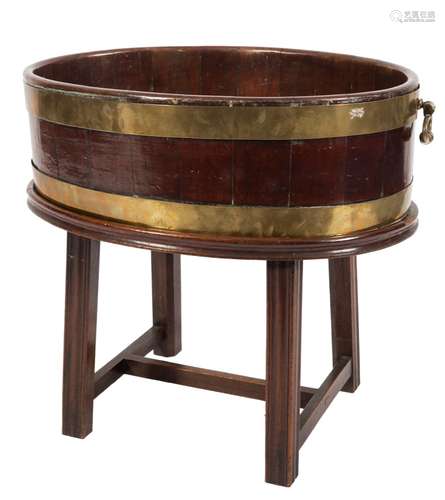 A George III mahogany and brass bound oval wine cooler on a stand:,