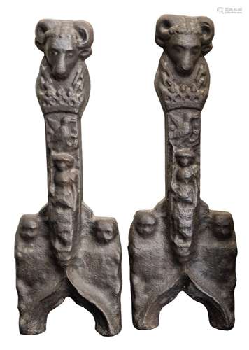 A pair of late 16th/early 17th Century cast iron andirons: with rams head terminals,