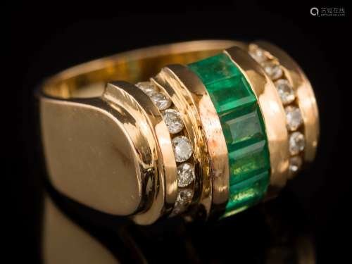 An emerald and diamond ring: centring a row of baguette-cut emeralds between single rows of