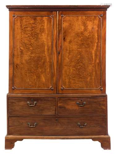 A George III mahogany linen press:, the upper part with a moulded dentil cornice,