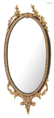 A 19th Century gilt gesso and ebonised oval mirror:, with tied laurel leaf cresting,