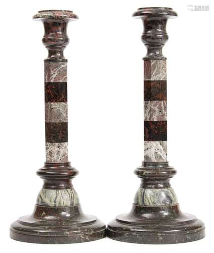 A pair of serpentine and marble candlesticks:,