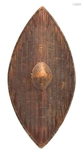 A West African woven parrying shield: of oval design with central wood boss,