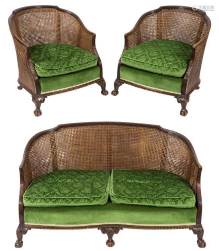 A 1920's carved walnut and beechwood three piece bergere suite:,