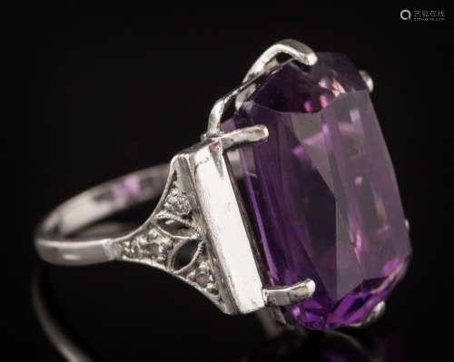 An amethyst dress ring: the rectangular amethyst approximately 17.2mm long x 12mm wide x 8.