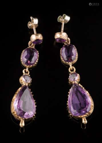 A pair of amethyst four-stone drop earrings: each suspending a pear-shaped drop in cut-down collet