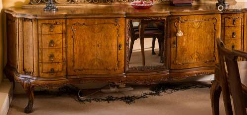 A carved and burr walnut veneer serpentine fronted sideboard of large size:, with rocaille,