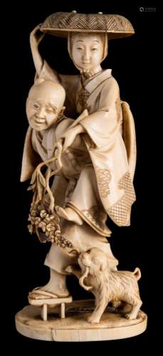 A Japanese carved okimono: of a semi-blind river crossing assistant carrying a young woman on his