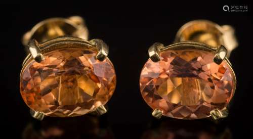 A pair of oval topaz single-stone ear-studs: each with an oval topaz approximately 9.2mm x 7.