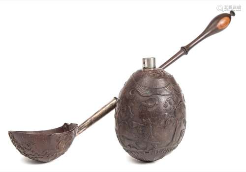 An 18th century white metal mounted and relief carved coconut: with plain cylindrical nozzle as the