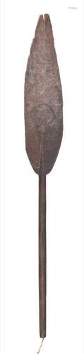 A Soloman Islands Buka paddle: of traditional design, the broad blade carved with mask decoration,