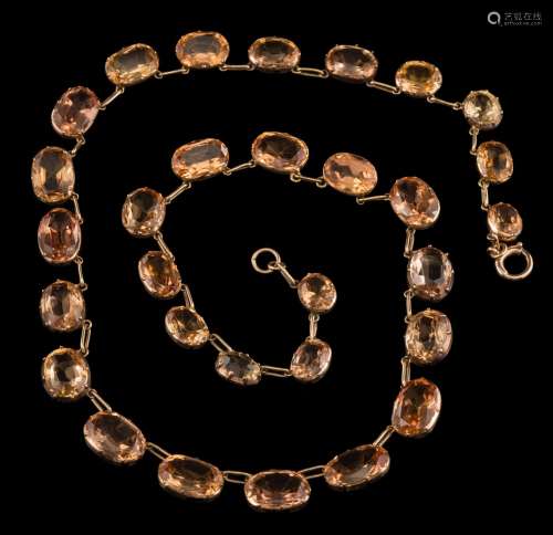 A graduated topaz riviere necklace: in cut-down collet settings,