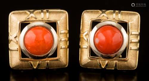 A pair of square coral single-stone stud/clip earrings: each centring a circular coral