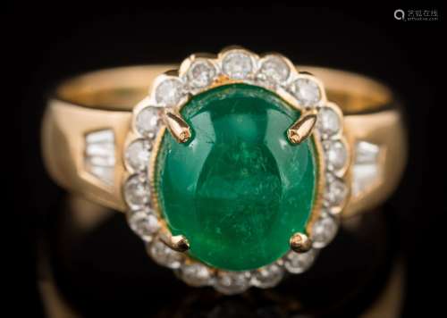 A cabochon emerald and diamond oval cluster ring: the oval cabochon emerald approximately 10.