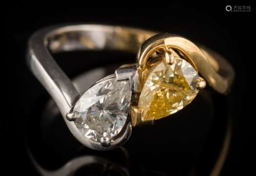 A pear-shaped natural fancy yellow diamond and diamond two-stone cross over ring: the pear-shaped