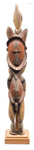 A Papua New Guinea (Maprik area) carved wood and polychrome decorated figure: surmounted by a