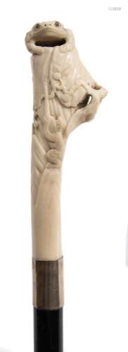 A late 19th century ebonised walking stick: the Japanese carved ivory handle decorated with a toad