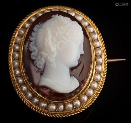 A Victorian layered agate cameo portrait brooch: the white agate cameo carved depicting a young