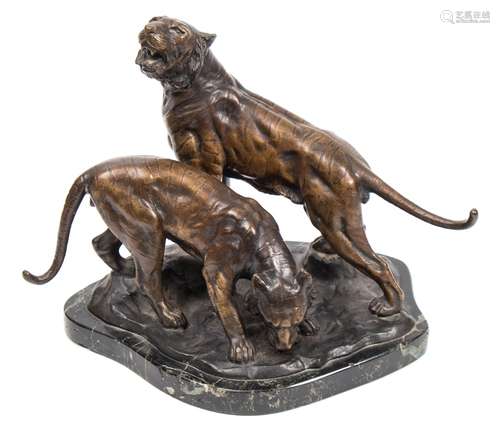 A bronze group of two tigers: mounted on a naturalistic base,