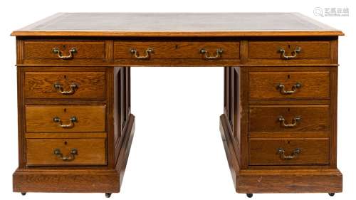 An Edwardian oak pedestal desk:, the rectangular top with a moulded edge,