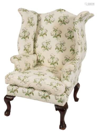 A stained beech frame wing armchair:, of shaped outline in the George III manner,