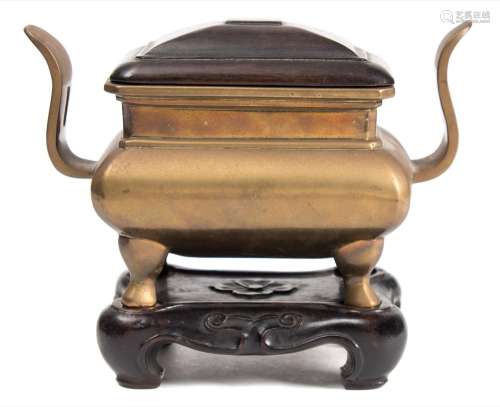 A Chinese polished bronze censer: of rectangular section with pierced curved handles and on