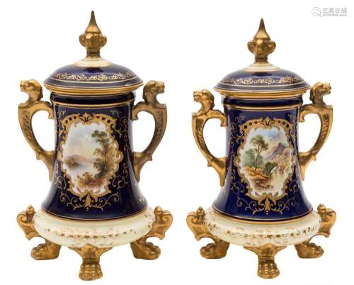 A pair of Coalport jars and covers: of tapering form set on four lion paw feet,