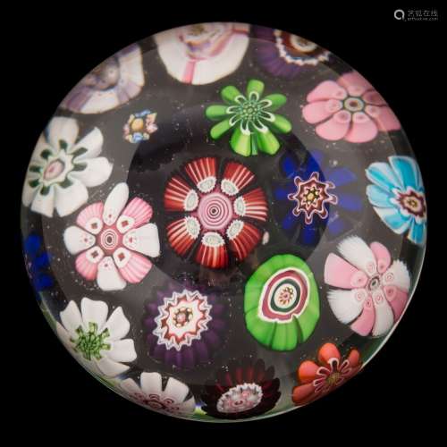 A Clichy spaced millefiori paperweight: set with a variety of coloured cabbage and other mixed