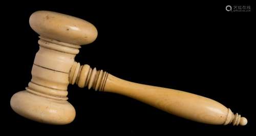 A late 19th/early 20th century ivory gavel: with ring turned head and handle, 12.5cm. long.