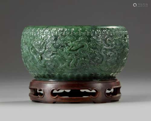 A CHINESE SPINACH GREEN JADE 'NINE DRAGONS' BOWL