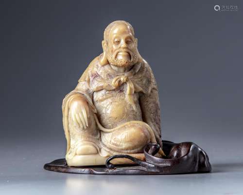 A CHINESE SOAPSTONE FIGURE WITH A ZITAN WOODEN STAND